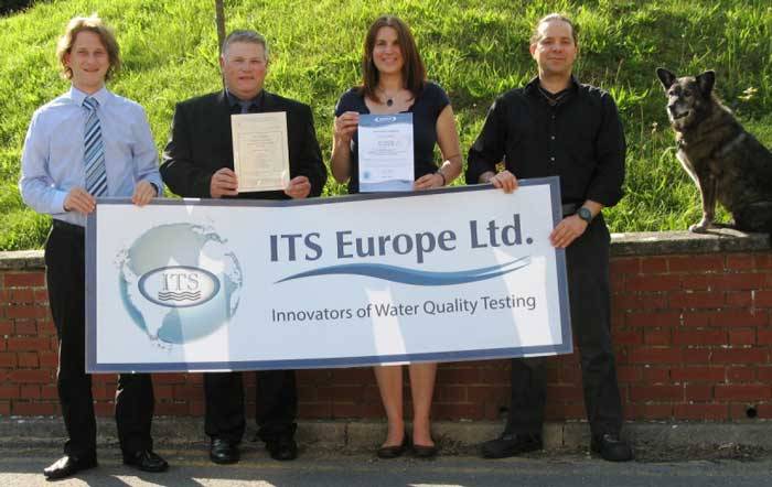 ITS Europe employees holding sign.